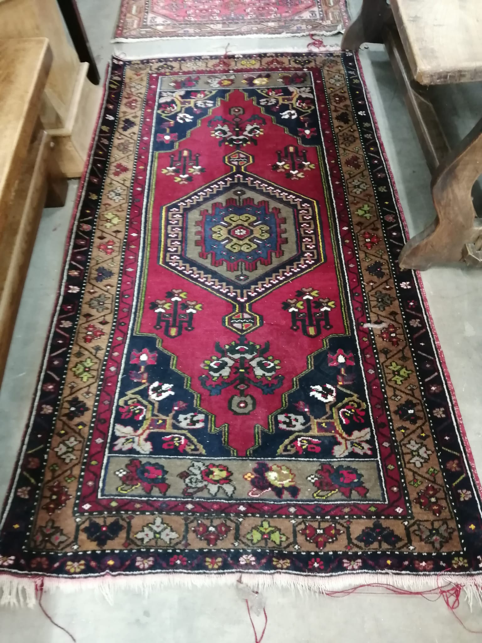 A Caucasian style burgundy ground rug and a North West Persian red ground rug, larger 194 x 106cm